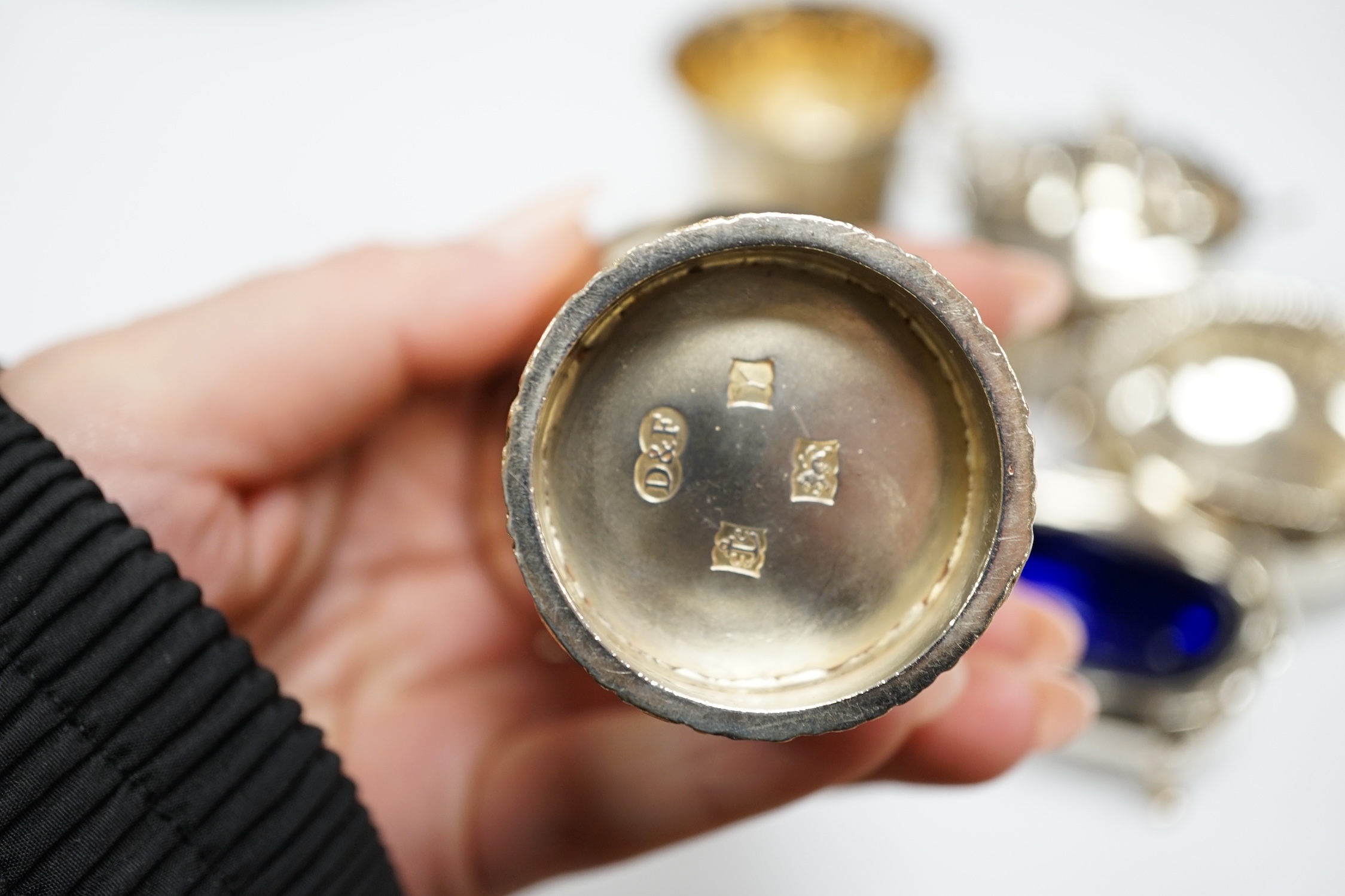 A modern pair of silver tots and five assorted silver condiments.